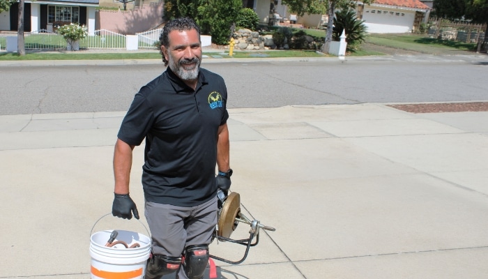 Bow Tie Plumber With drain Clearing Equipment